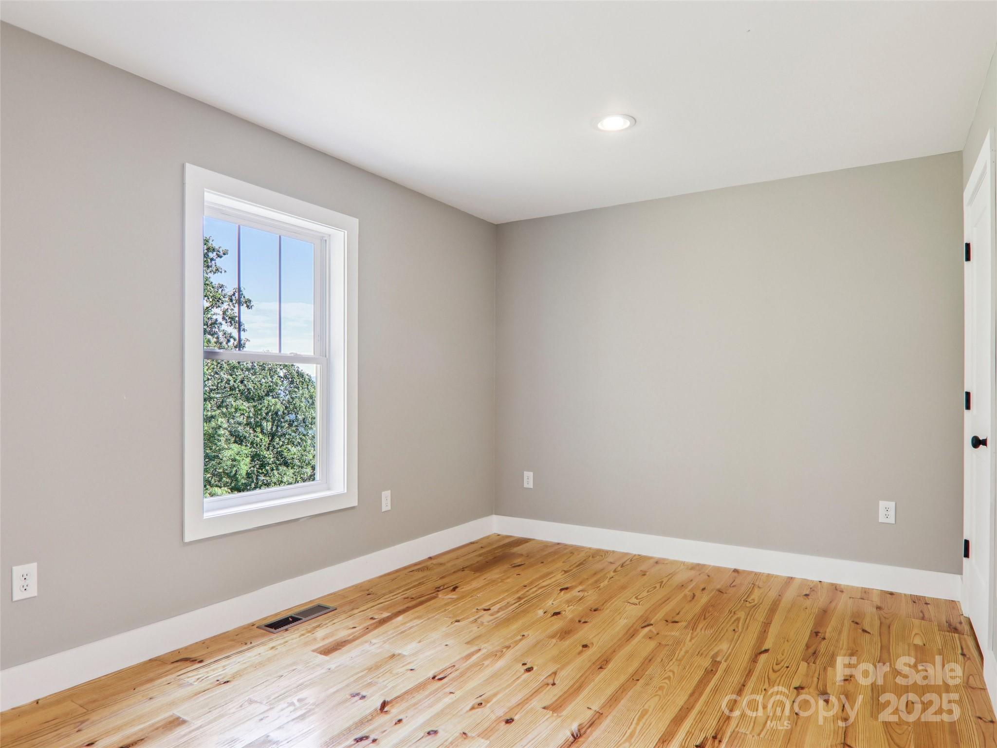366 Ben Nevis Road Brevard, NC 28712 - Photo 31 of 48 a view of an empty room with wooden floor and a window