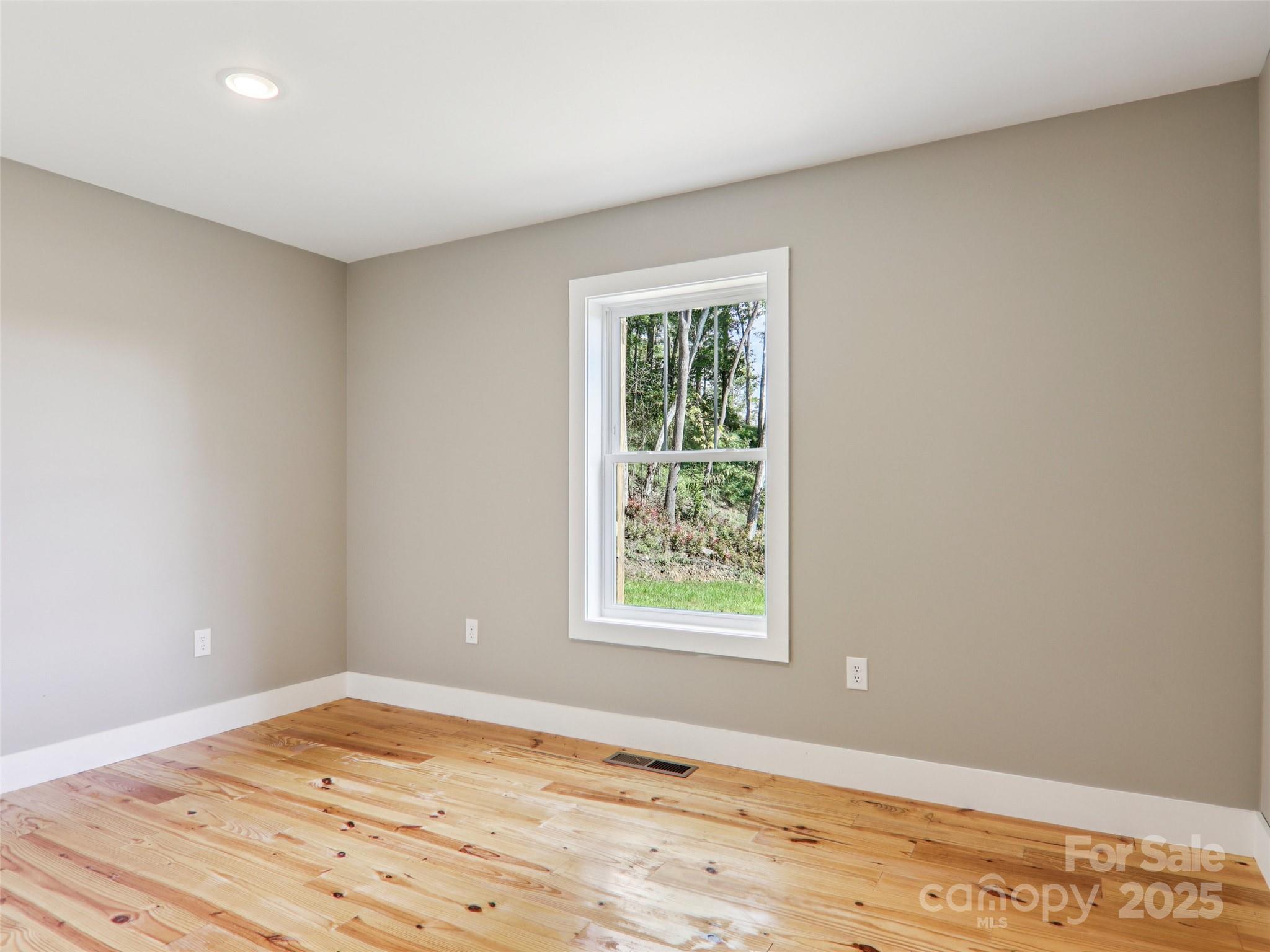 366 Ben Nevis Road Brevard, NC 28712 - Photo 32 of 48 an empty room with wooden floor and windows