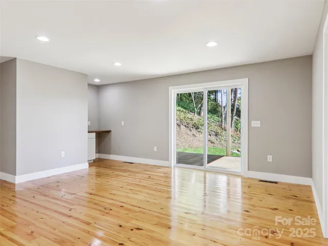 a view of balcony with wooden floor and fence