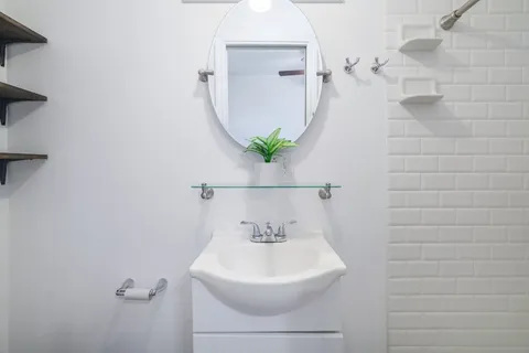 a bathroom with a sink a mirror and a shower