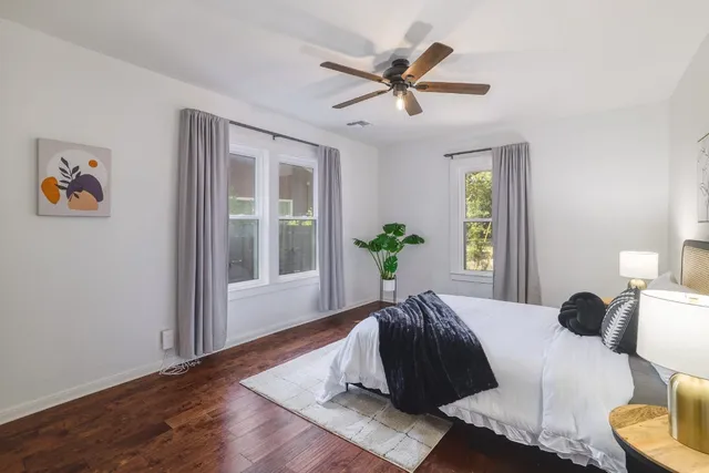 a bedroom with a large bed and a window