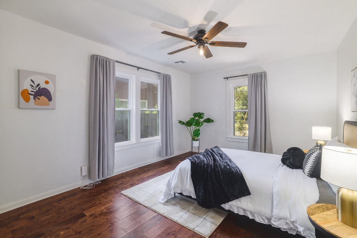 6511 Chesterfield Avenue Austin, TX 78752 - Photo 14 of 27 a bedroom with a large bed and a window