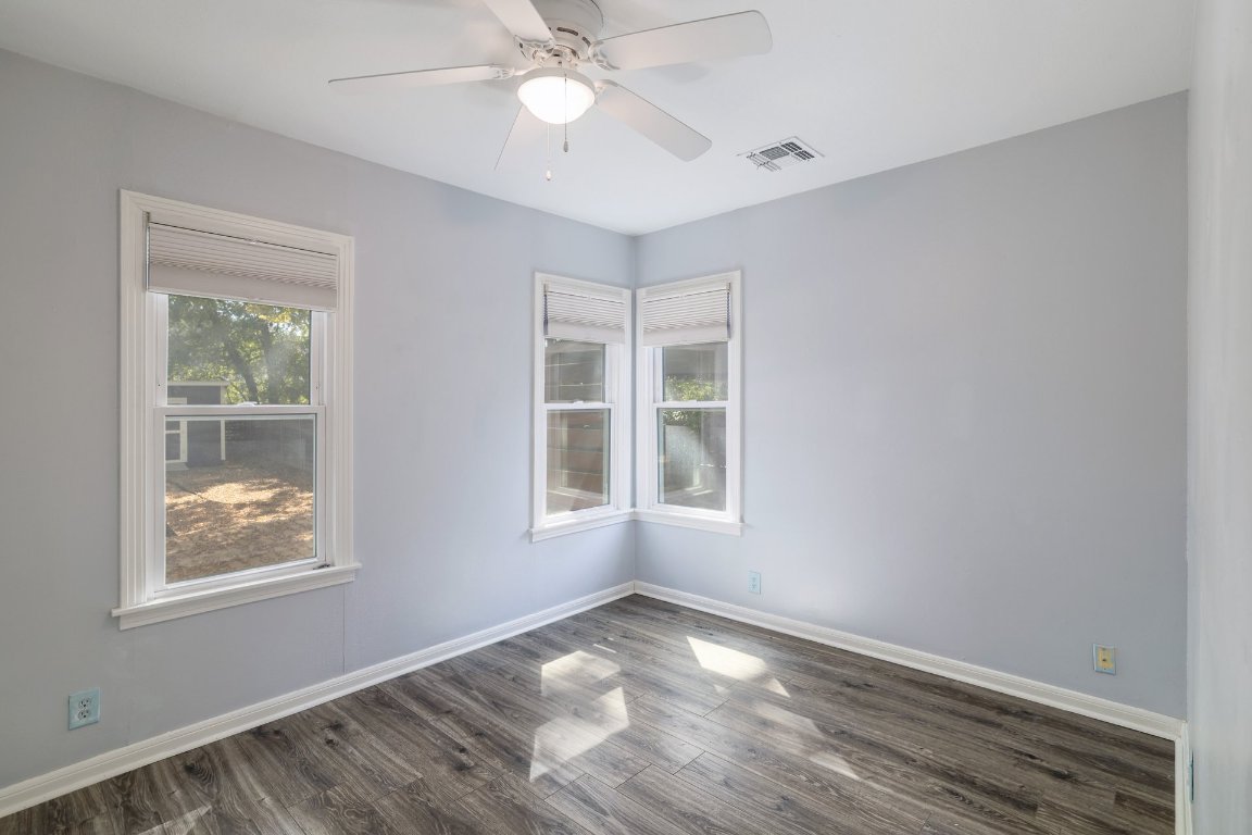 6511 Chesterfield Avenue Austin, TX 78752 - Photo 17 of 27 an empty room with a window and ceiling fan
