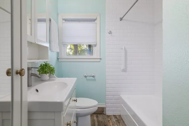 a bathroom with a sink toilet and shower