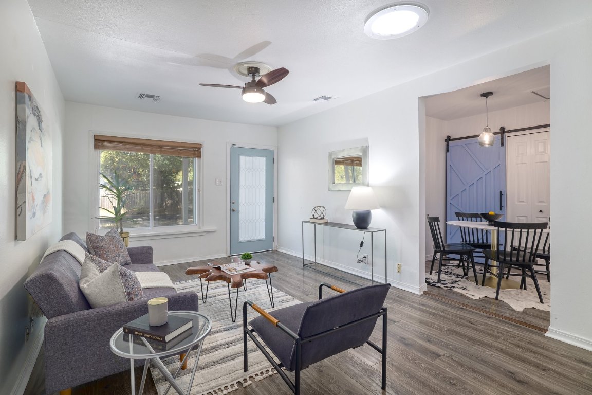 6511 Chesterfield Avenue Austin, TX 78752 - Photo 4 of 27 a living room with furniture a wooden floor and a window