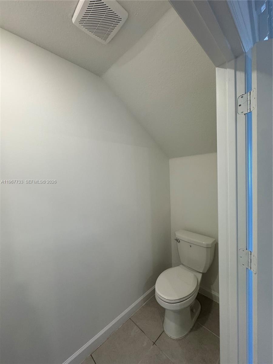 12420 Southwest 248th Street, Unit 7 Homestead, FL 33032 - Photo 20 of 31 a white toilet sitting next to a shower