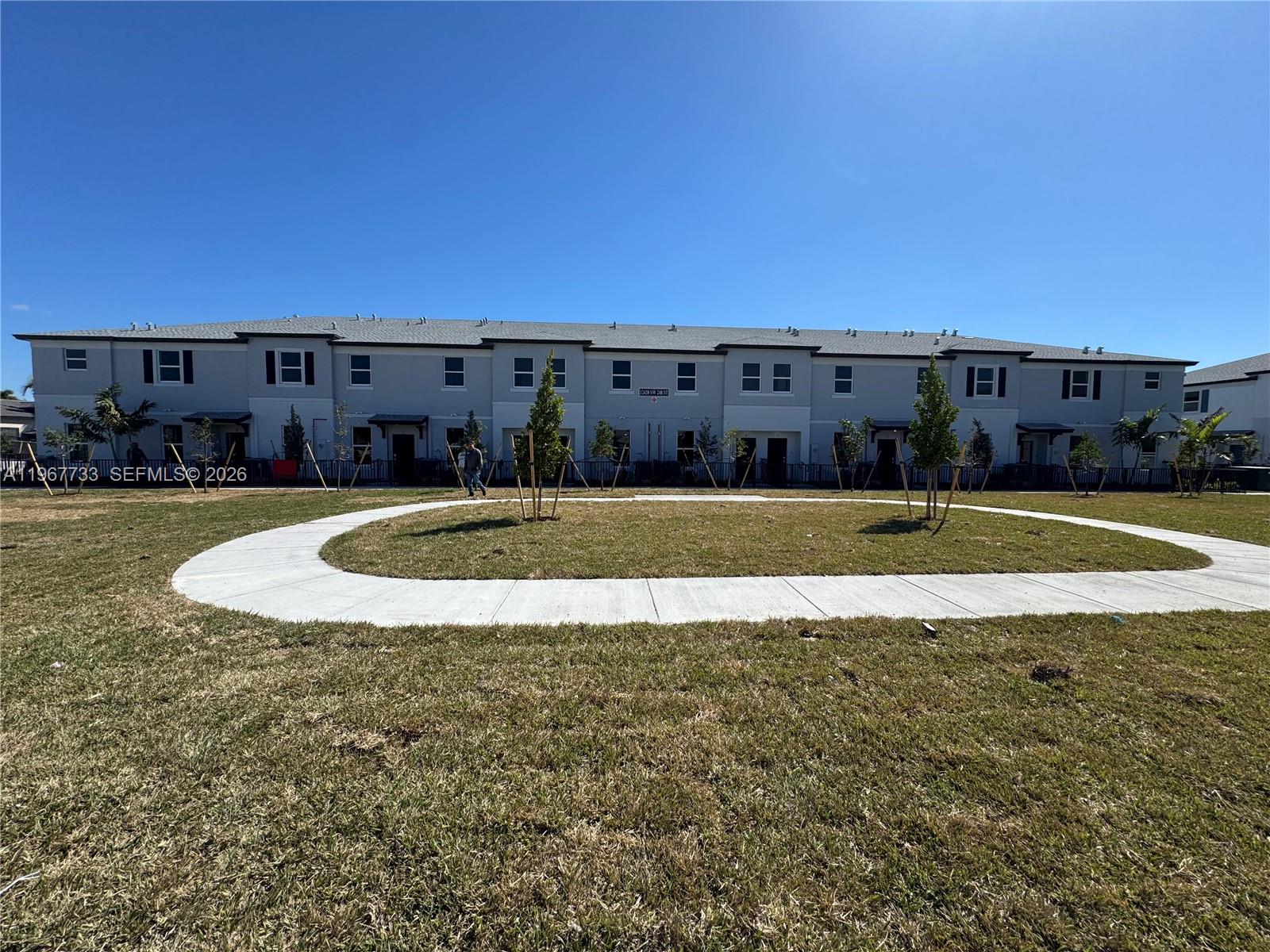 12420 Southwest 248th Street, Unit 7 Homestead, FL 33032 - Photo 2 of 31 a view of a swimming pool with an outdoor seating and a yard