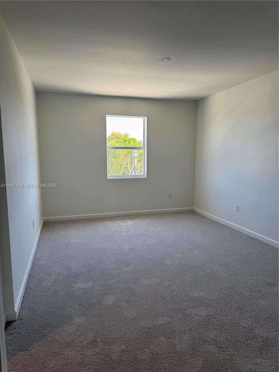 12420 Southwest 248th Street, Unit 7 Homestead, FL 33032 - Photo 23 of 31 a view of an empty room with a window