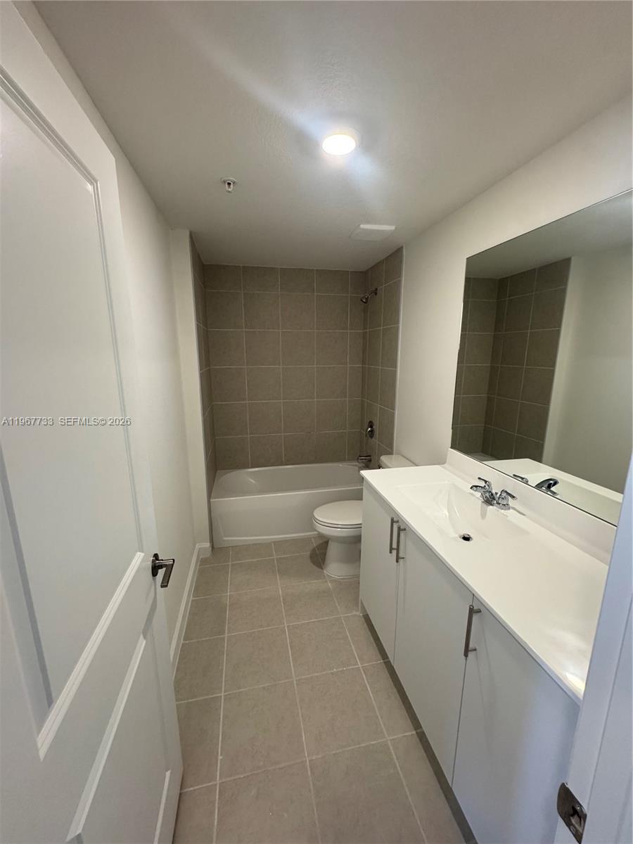 12420 Southwest 248th Street, Unit 7 Homestead, FL 33032 - Photo 7 of 31 a bathroom with a double vanity sink toilet mirror and shower