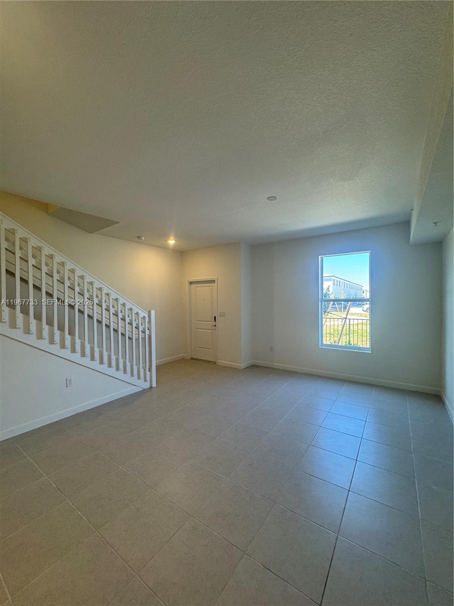 12420 Southwest 248th Street, Unit 7 Homestead, FL 33032 - Photo 8 of 31 an empty room with windows