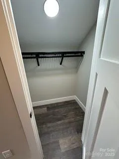 a view of walk in closet with empty racks