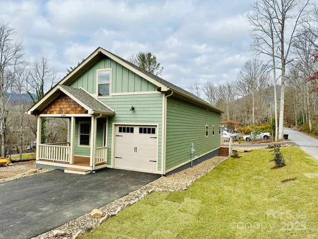 a view of a house with a yard and porch