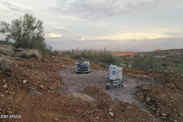 a view of a fire pit with large trees