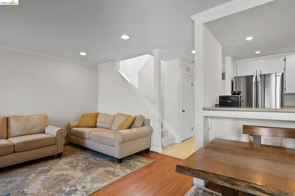 a living room with furniture and a kitchen