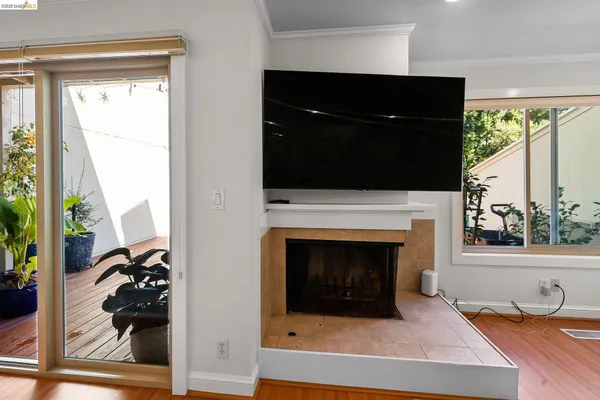 a living room with a fireplace and a flat screen tv