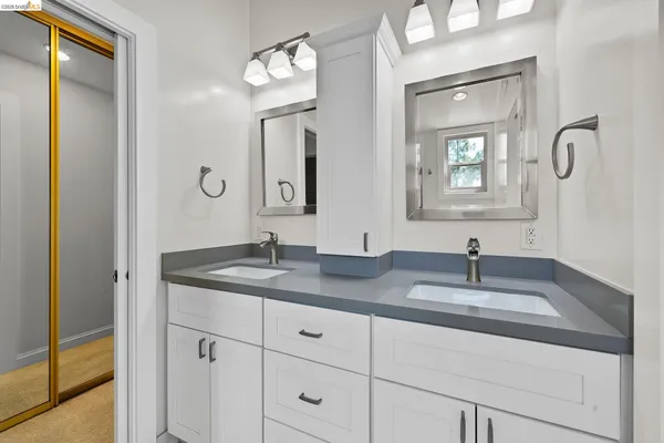 a bathroom with a granite countertop sink mirror and vanity
