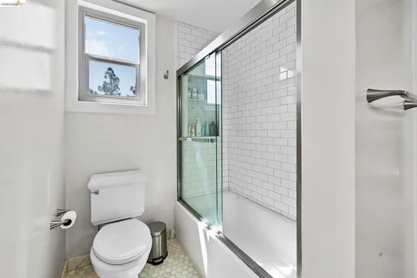 a white toilet sitting next to a bathroom sink