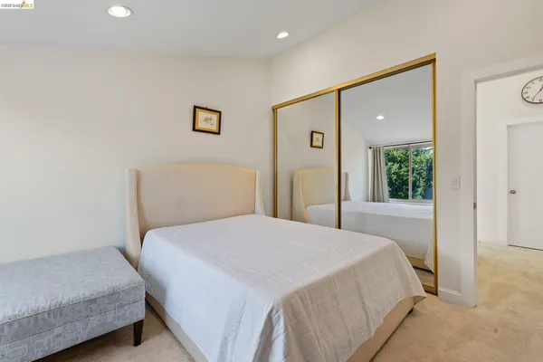 a bedroom with a bed and a potted plant