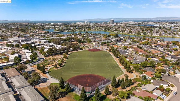 an aerial view of residential houses with outdoor space