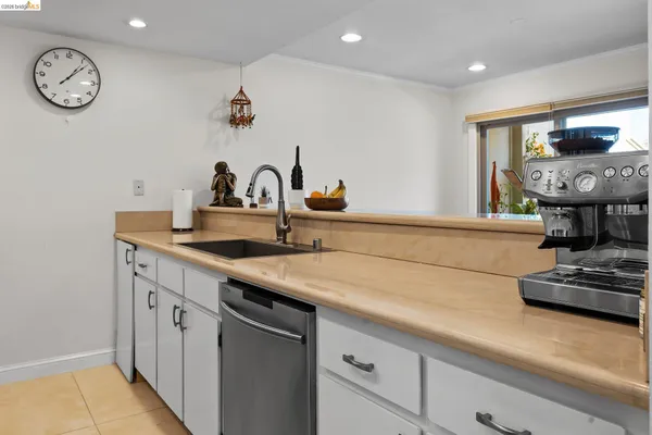 a kitchen with kitchen island a sink stainless steel appliances and cabinets