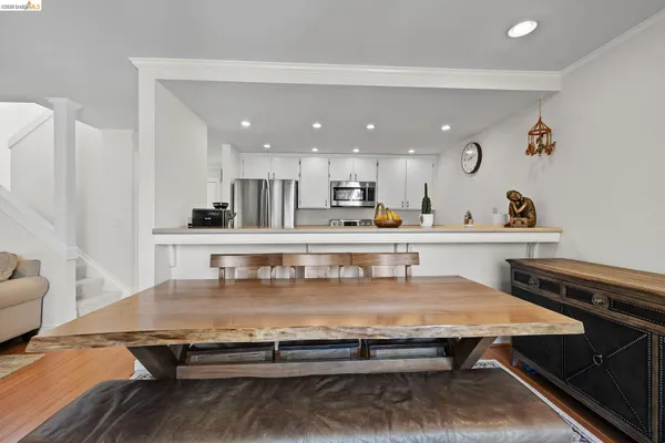a kitchen with kitchen island stainless steel appliances a sink and counter space