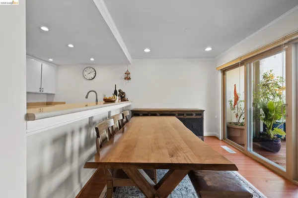 a kitchen with kitchen island a counter top space a sink stainless steel appliances and cabinets