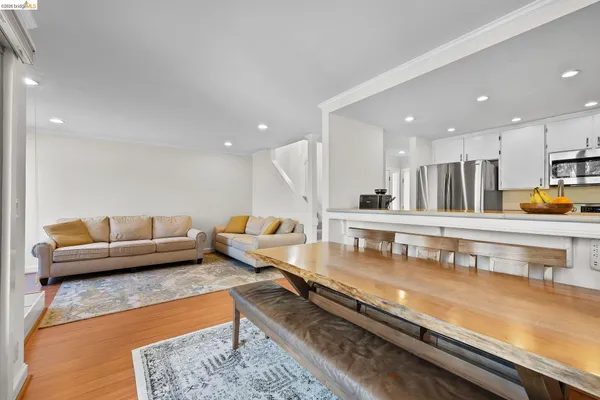 a living room with furniture and kitchen view