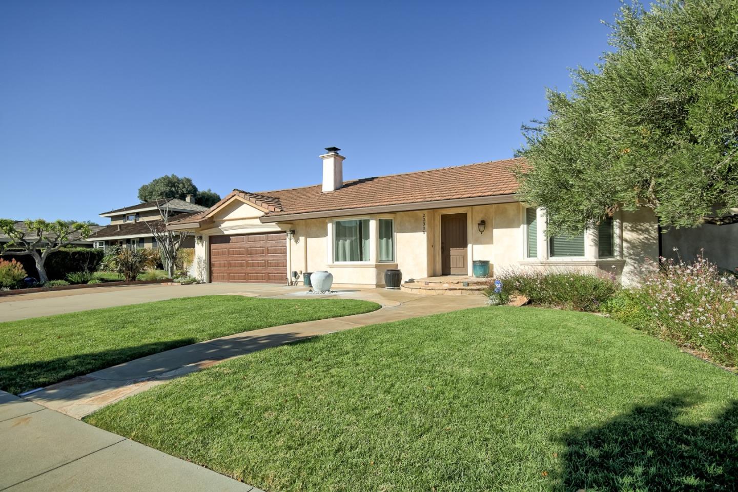 a front view of a house with a garden and porch