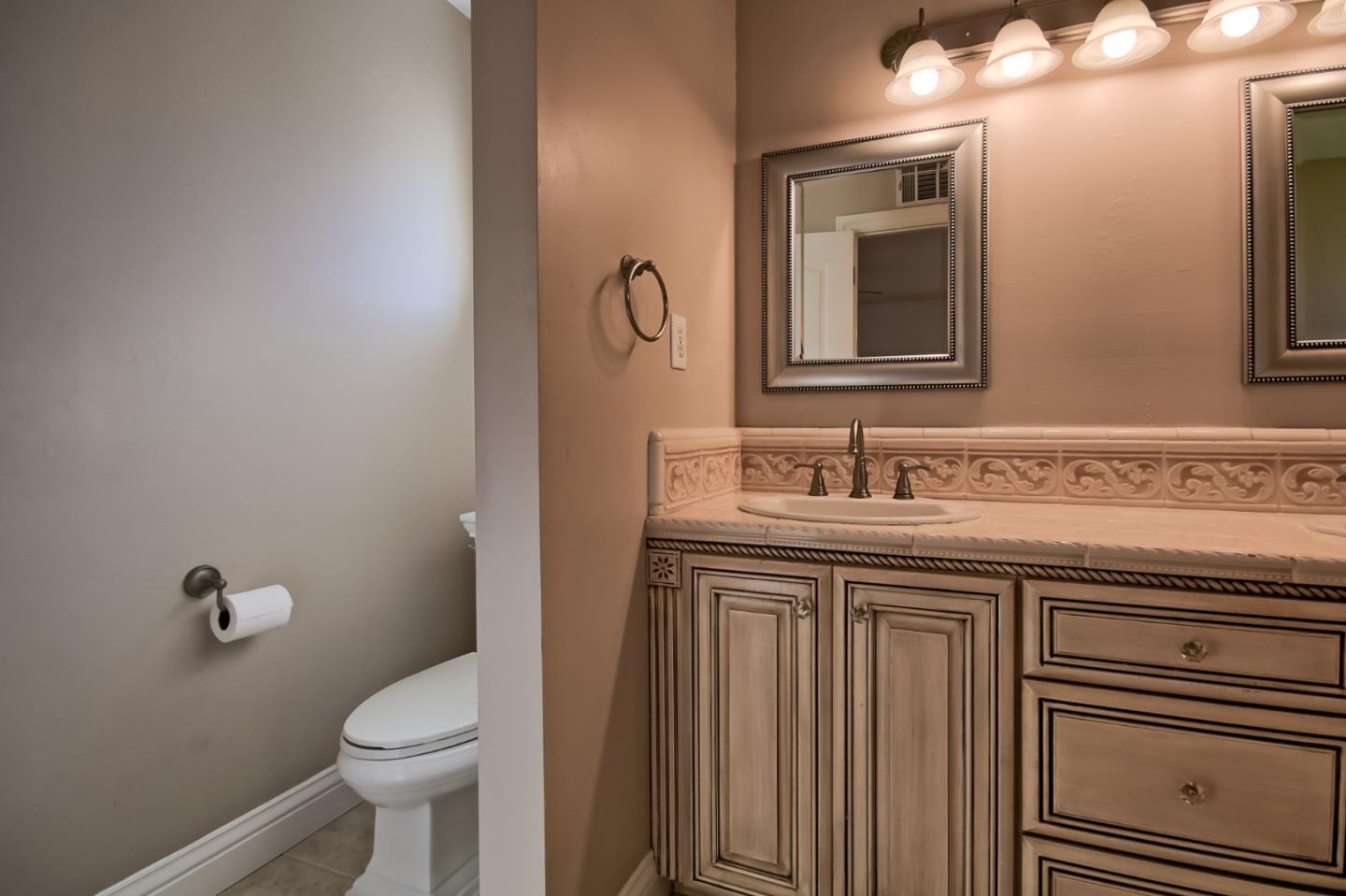 22305 Montera Drive Salinas, CA 93908 - Photo 12 of 20 a bathroom with a granite countertop toilet sink and mirror