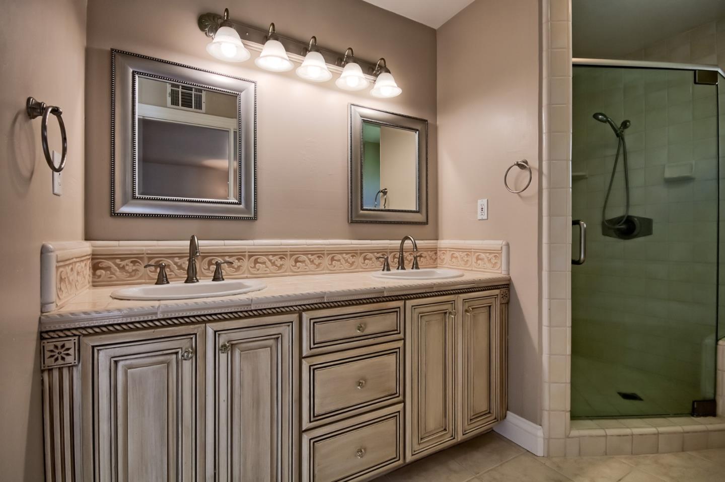 22305 Montera Drive Salinas, CA 93908 - Photo 10 of 20 a bathroom with a granite countertop sink and a mirror