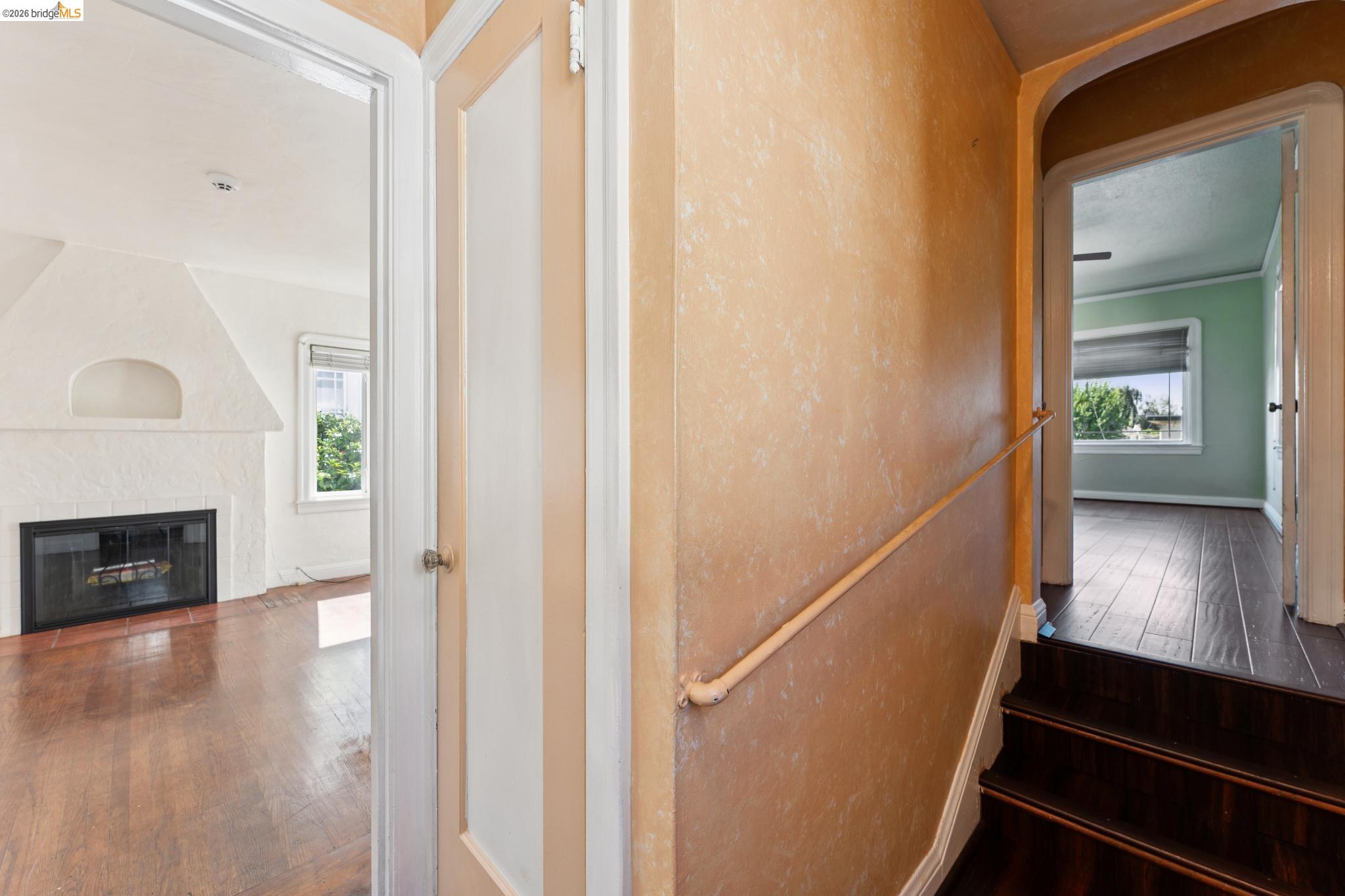 978 43rd Street Oakland, CA 94608 - Photo 24 of 46 Interior hallway with textured wall finish and a partial staircase featuring wood-finish treads
