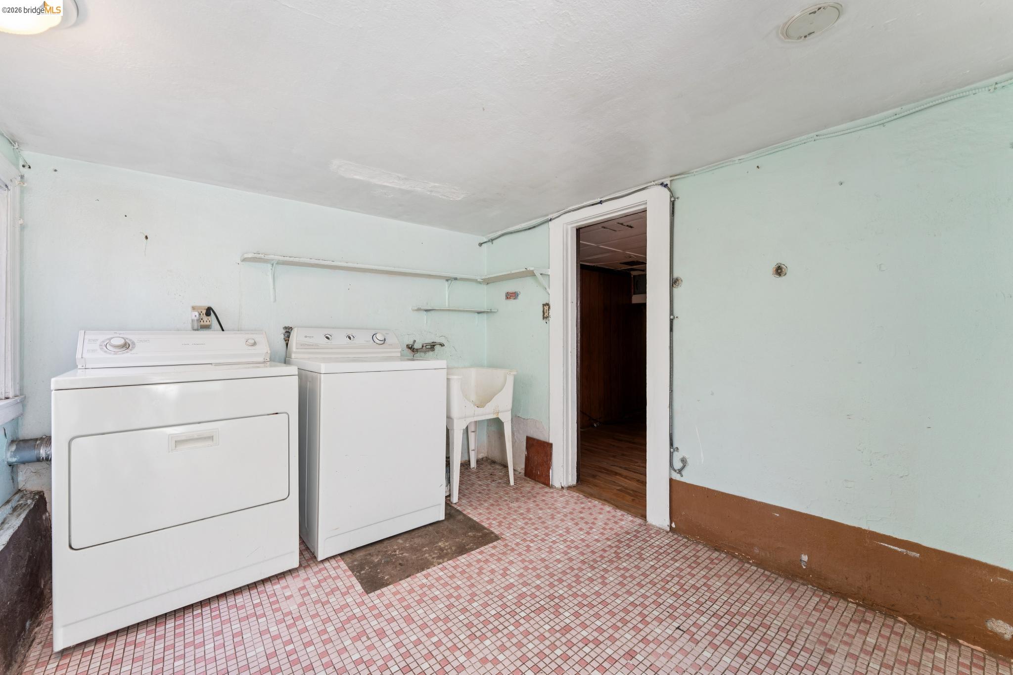 978 43rd Street Oakland, CA 94608 - Photo 29 of 46 Laundry area featuring a washer and dryer, utility sink, and tiled flooring