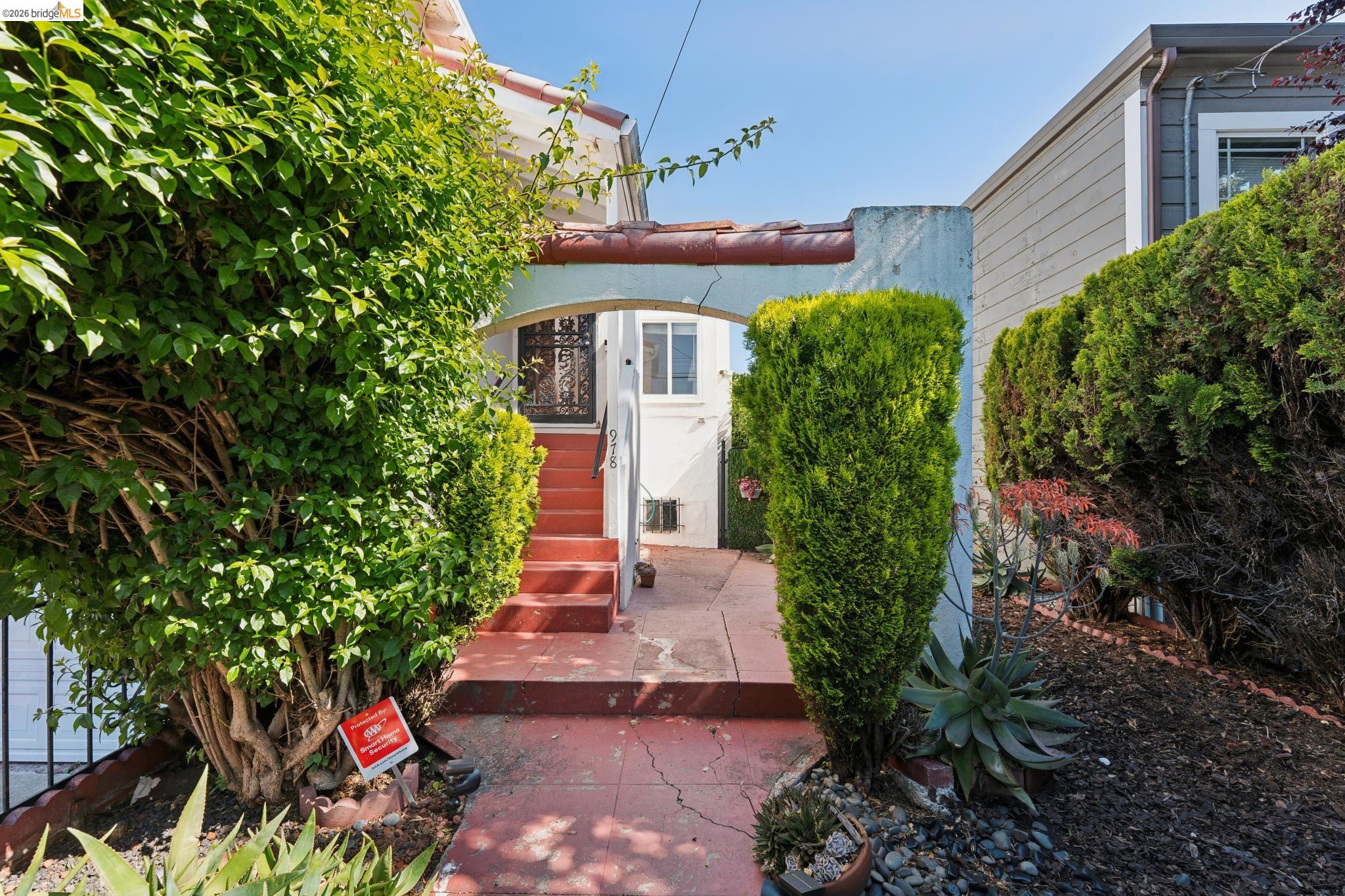 978 43rd Street Oakland, CA 94608 - Photo 4 of 46 Front walkway leading to an arched entry with red-toned steps