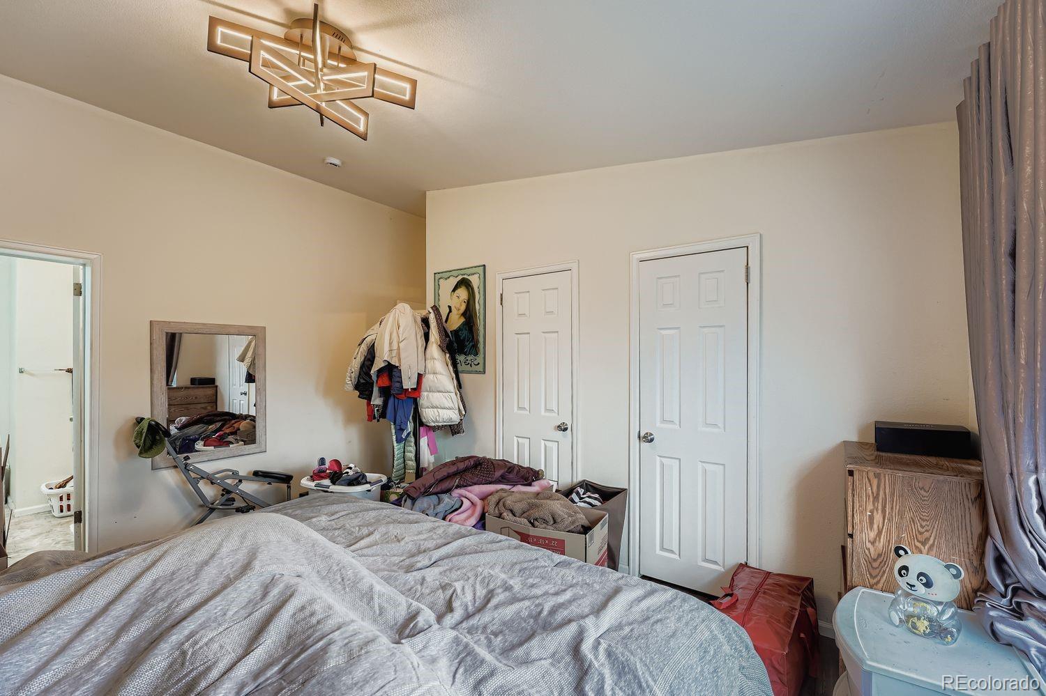 7393 Raleigh Street Westminster, CO 80030 - Photo 12 of 22 a bedroom with a bed and wooden floor