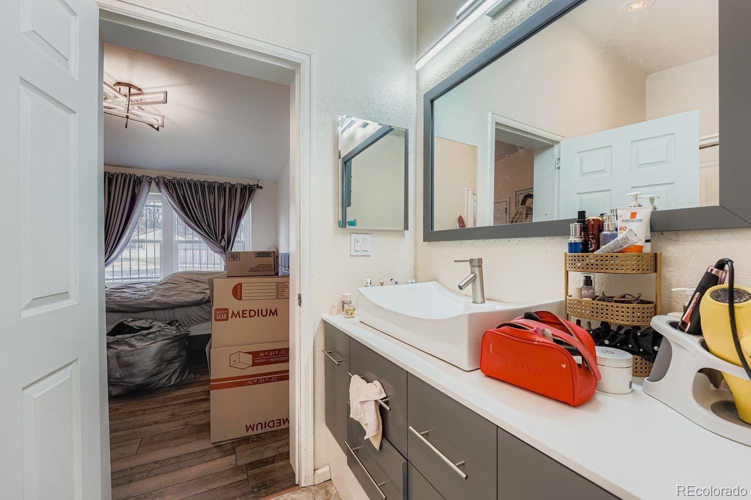 7393 Raleigh Street Westminster, CO 80030 - Photo 15 of 22 a bathroom with a sink and a mirror