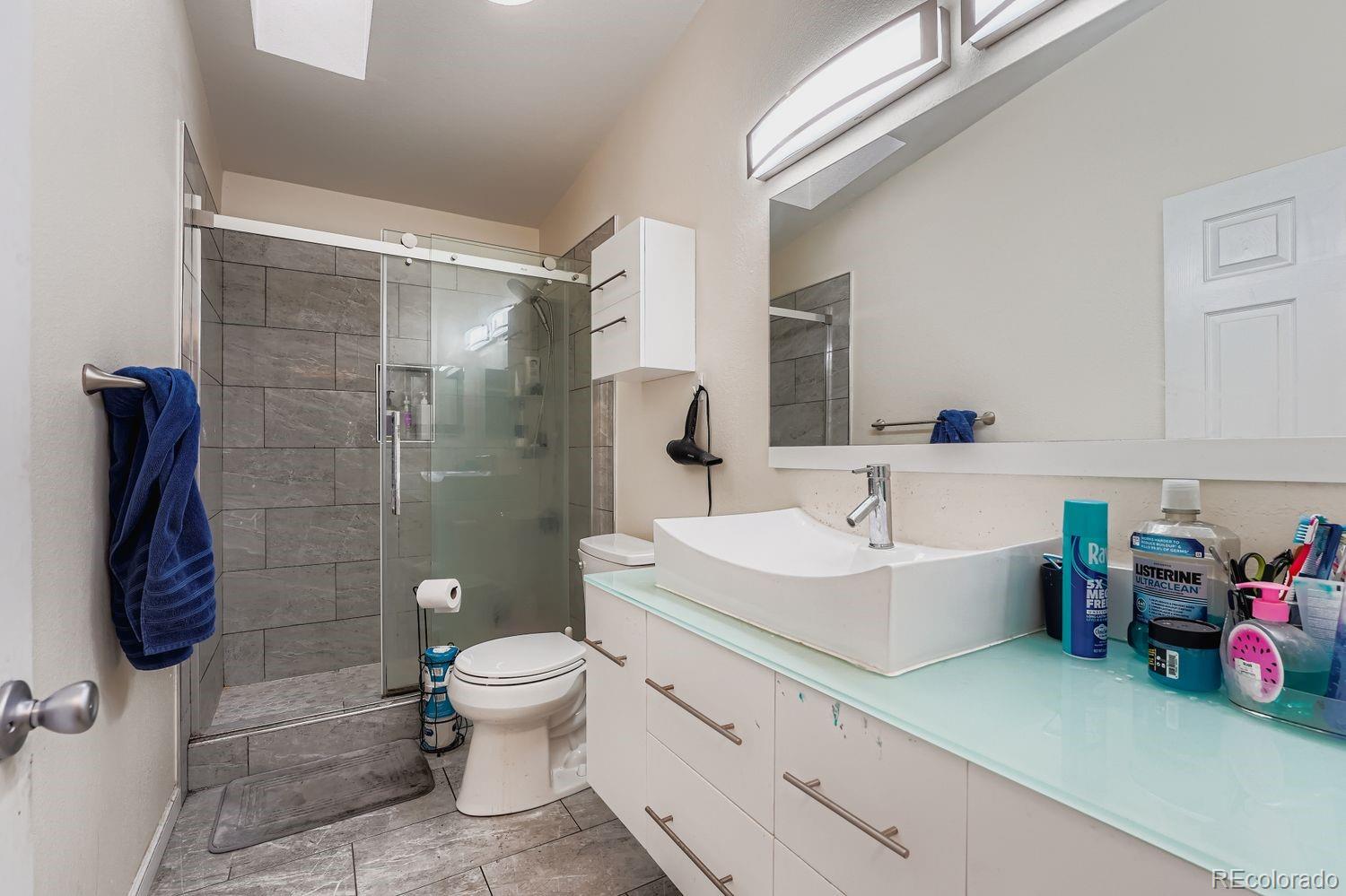 7393 Raleigh Street Westminster, CO 80030 - Photo 17 of 22 a bathroom with a sink toilet tub and shower