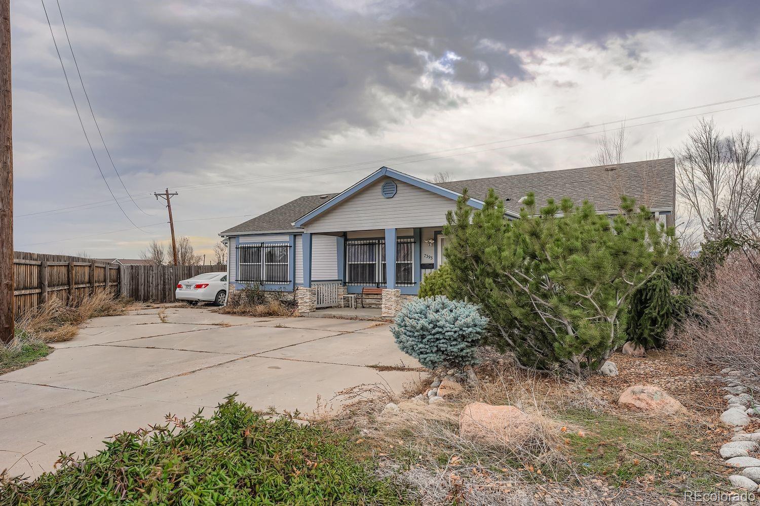 7393 Raleigh Street Westminster, CO 80030 - Photo 2 of 22 a front view of a house with garden