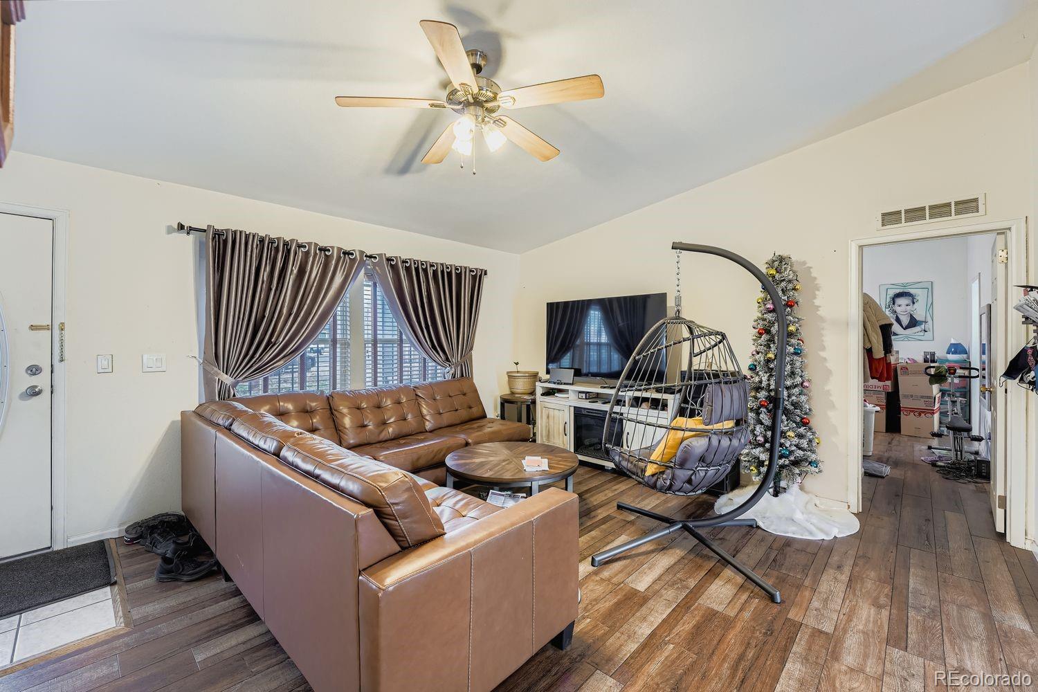 7393 Raleigh Street Westminster, CO 80030 - Photo 5 of 22 a living room with furniture and a wooden floor
