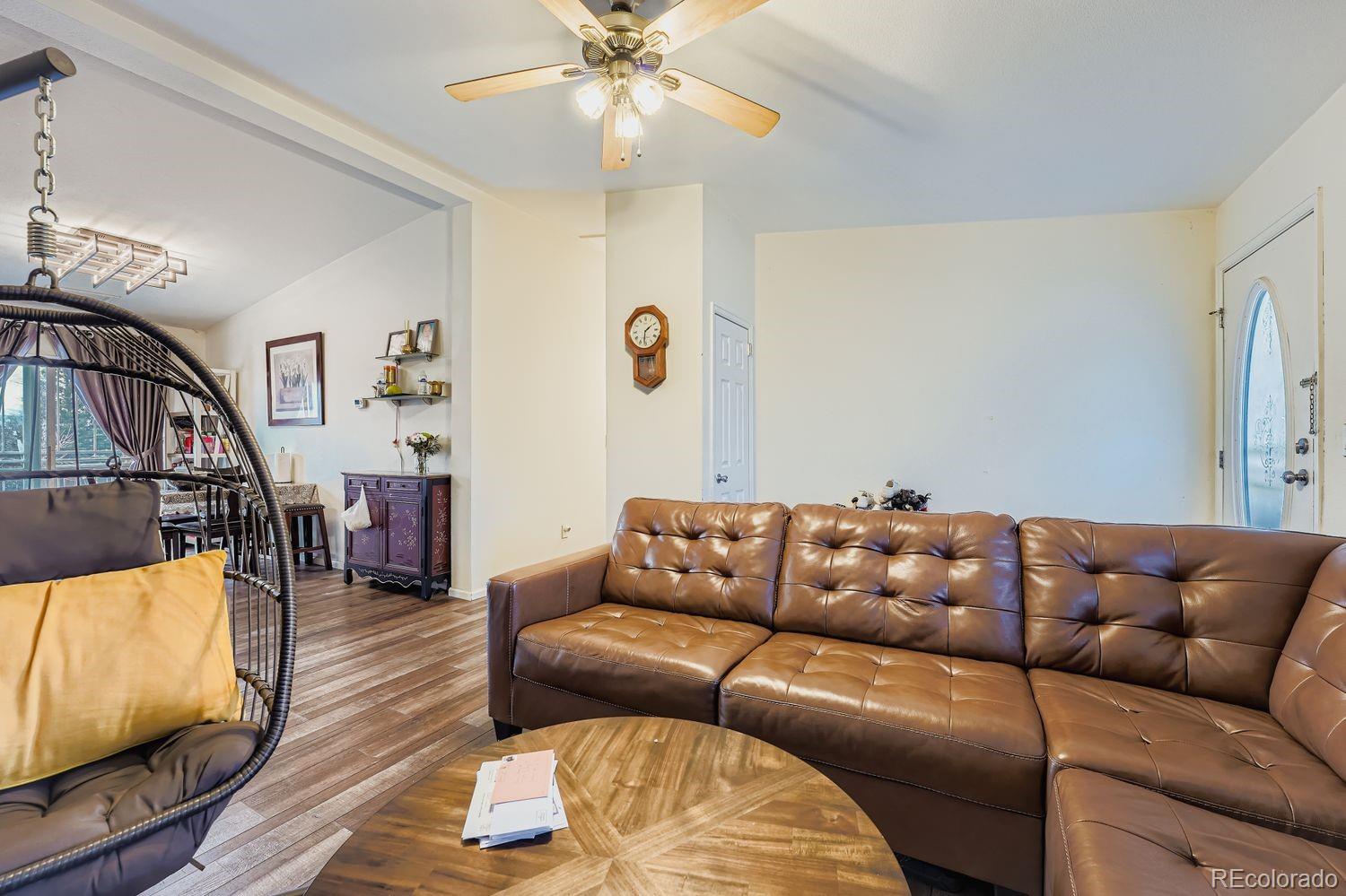 7393 Raleigh Street Westminster, CO 80030 - Photo 7 of 22 a living room with furniture and a flat screen tv