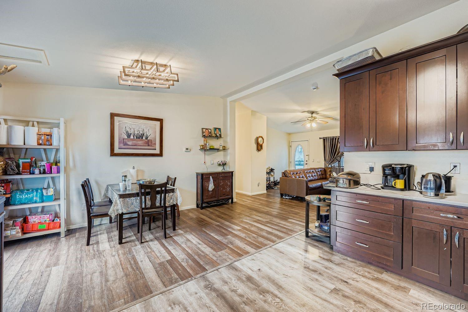 7393 Raleigh Street Westminster, CO 80030 - Photo 9 of 22 a view of a dining room with furniture and wooden floor