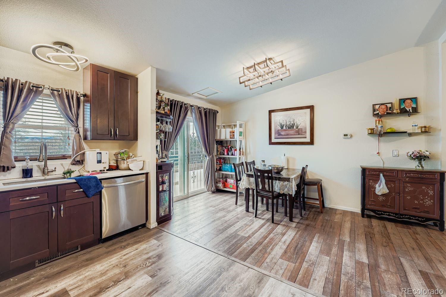 7393 Raleigh Street Westminster, CO 80030 - Photo 10 of 22 a kitchen with stainless steel appliances granite countertop a refrigerator and a stove top oven