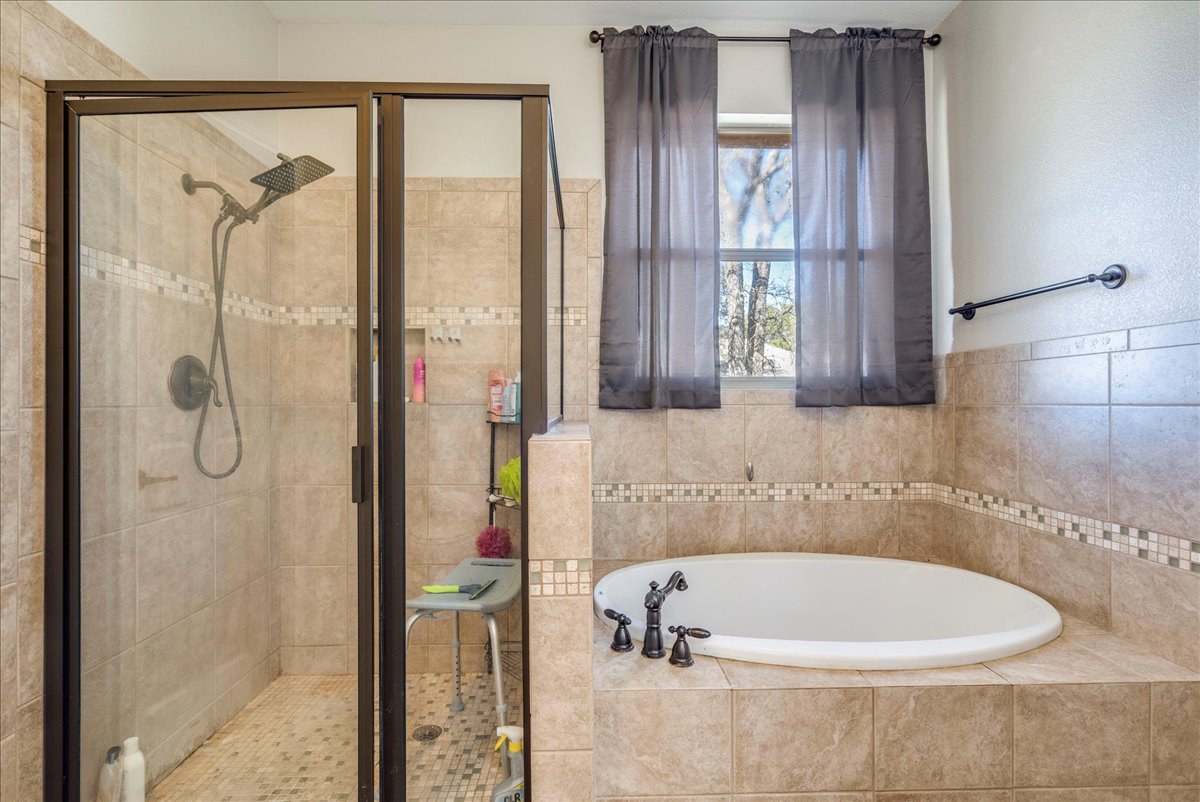 11 Rhapsody Lane Wimberley, TX 78676 - Photo 15 of 35 a bathroom with a bathtub and a shower