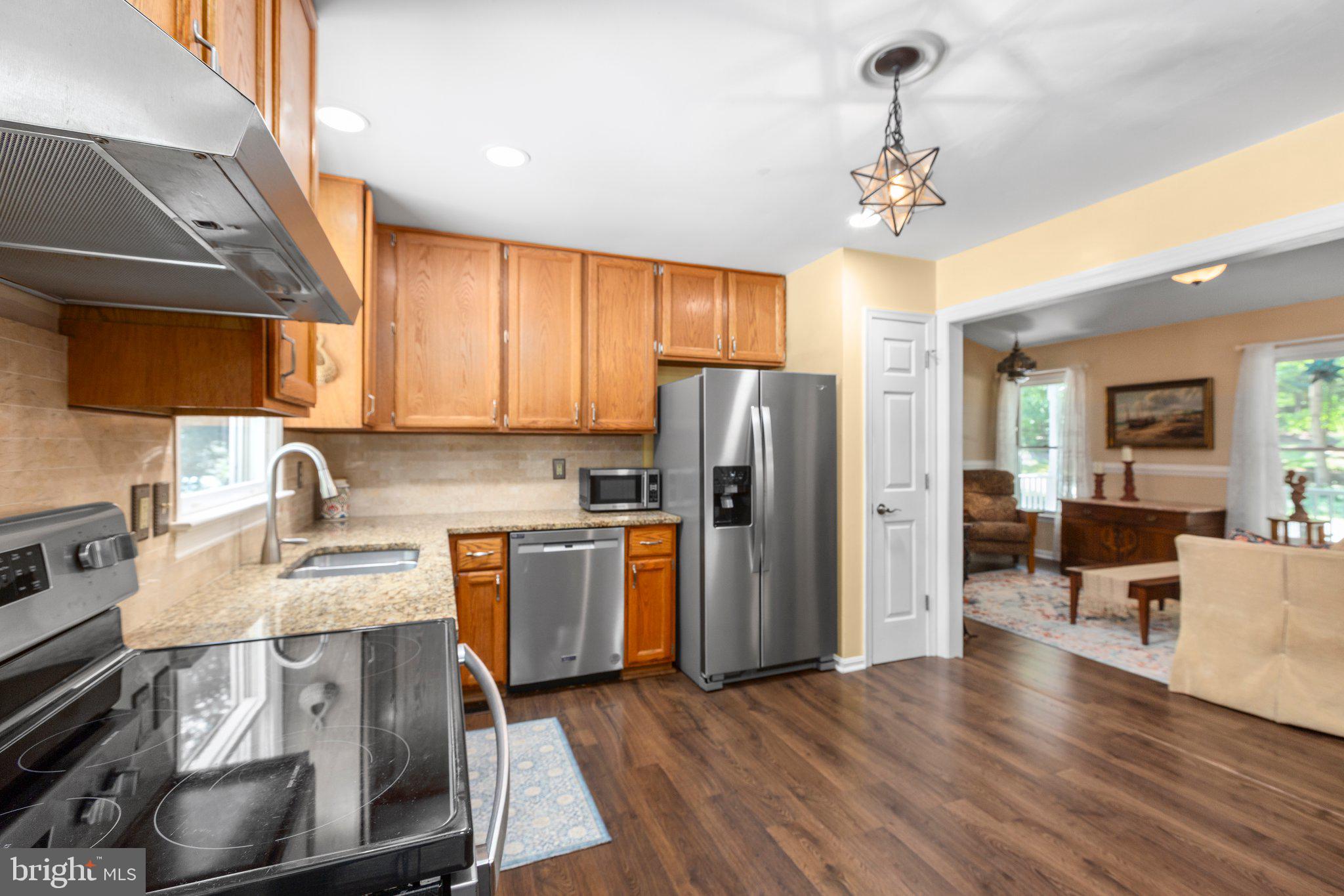 228 Cedar Ridge Drive Ruther Glen, VA 22546 - Photo 14 of 77 a kitchen with stainless steel appliances granite countertop a refrigerator stove top oven a sink and dishwasher