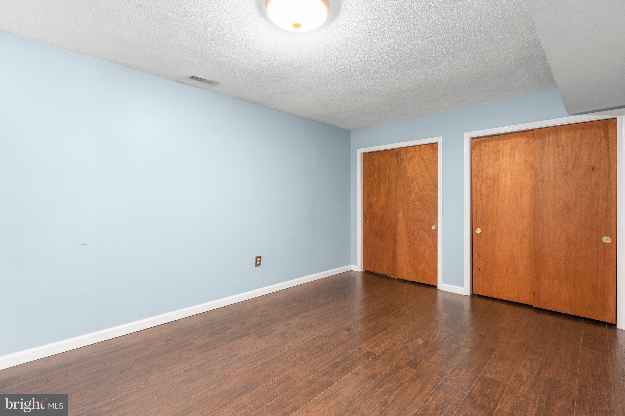 228 Cedar Ridge Drive Ruther Glen, VA 22546 - Photo 36 of 77 a view of an empty room with wooden floor and a window