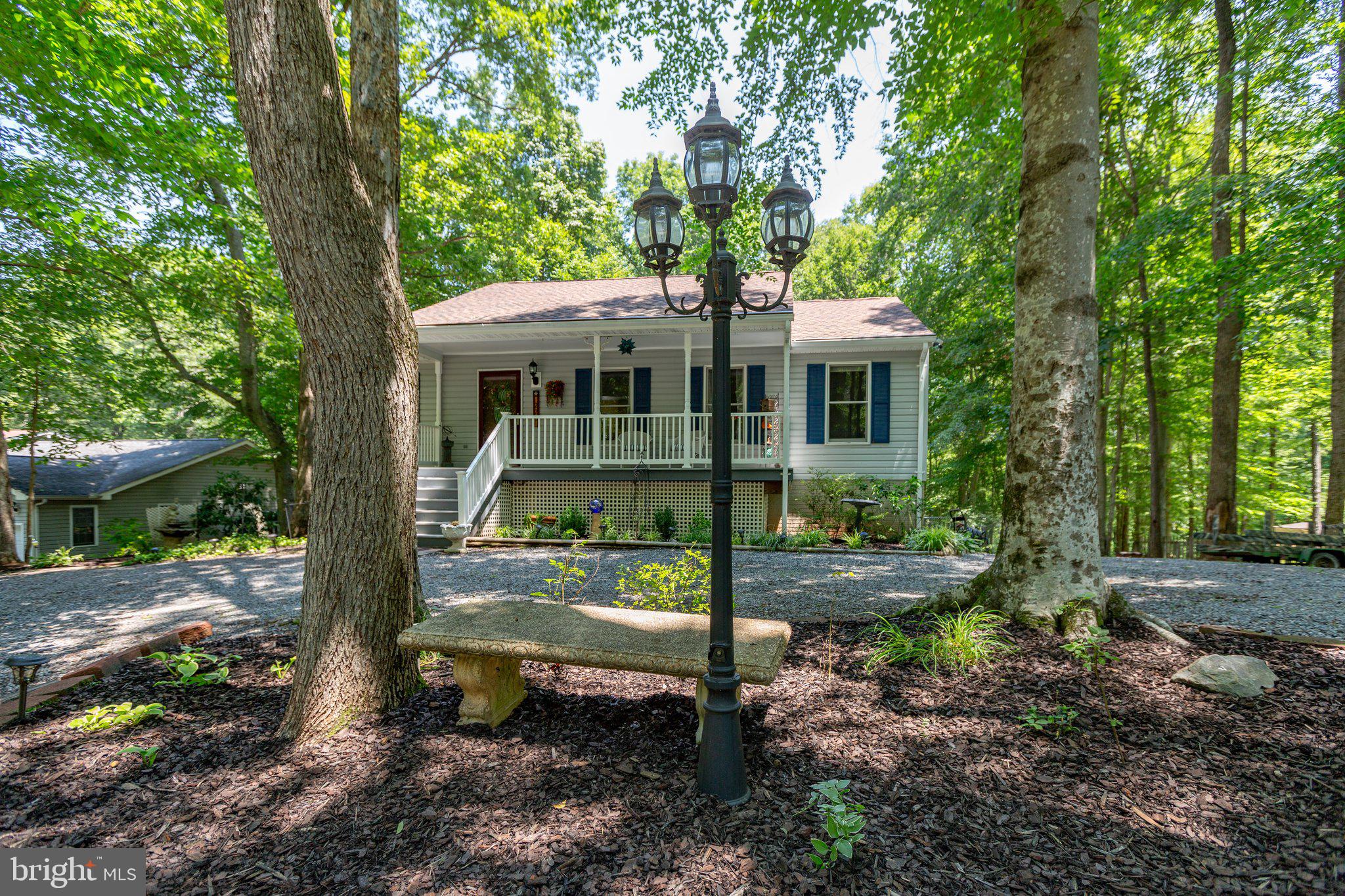 228 Cedar Ridge Drive Ruther Glen, VA 22546 - Photo 4 of 77 a view of a small house in the middle of a yard