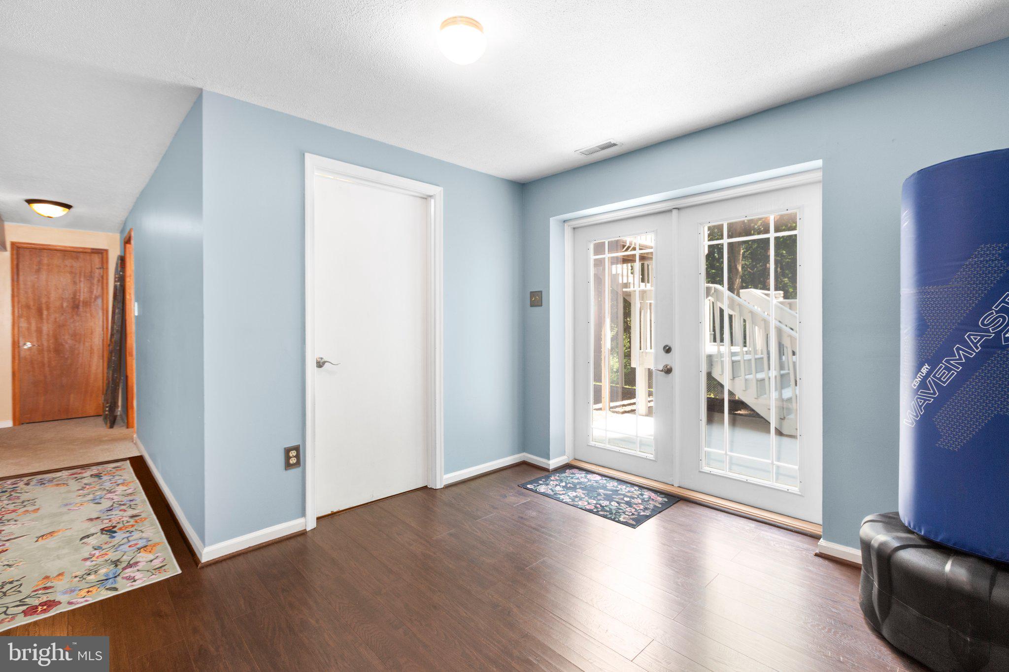 228 Cedar Ridge Drive Ruther Glen, VA 22546 - Photo 41 of 77 an empty room with wooden floor and windows