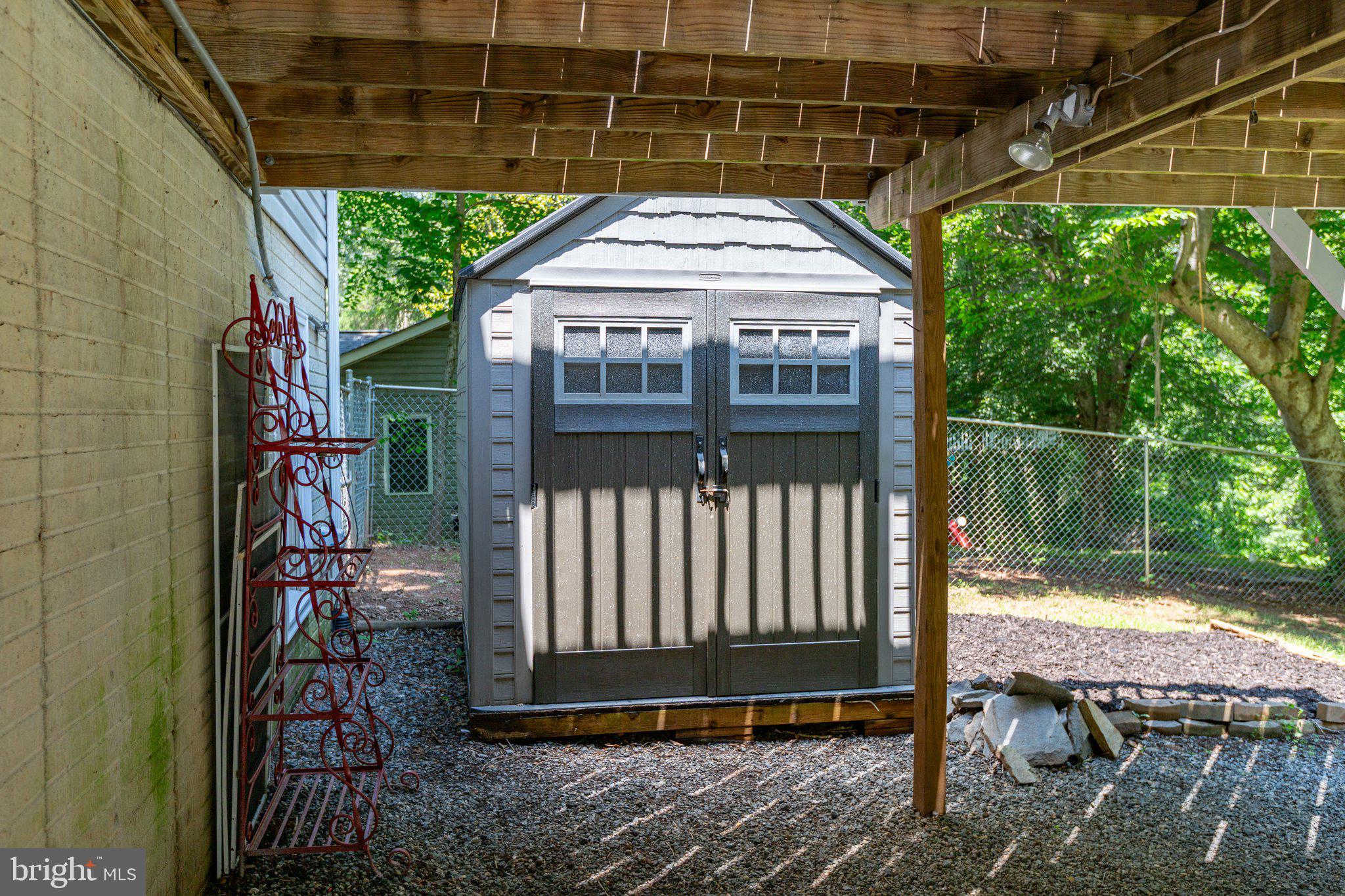 228 Cedar Ridge Drive Ruther Glen, VA 22546 - Photo 57 of 77 a view of a backyard with a small cabin and a chair