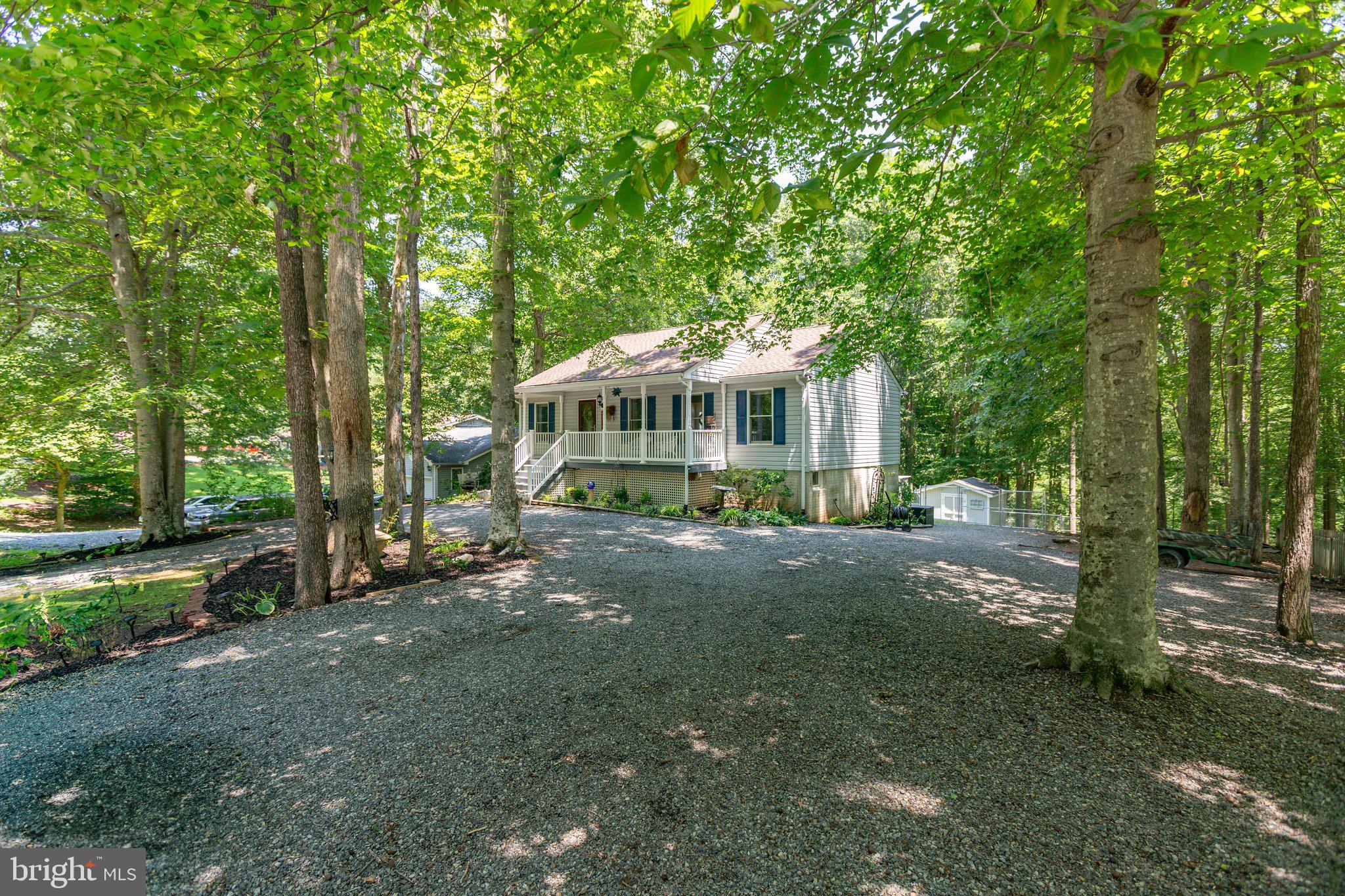 228 Cedar Ridge Drive Ruther Glen, VA 22546 - Photo 61 of 77 a view of a house with a yard and sitting area