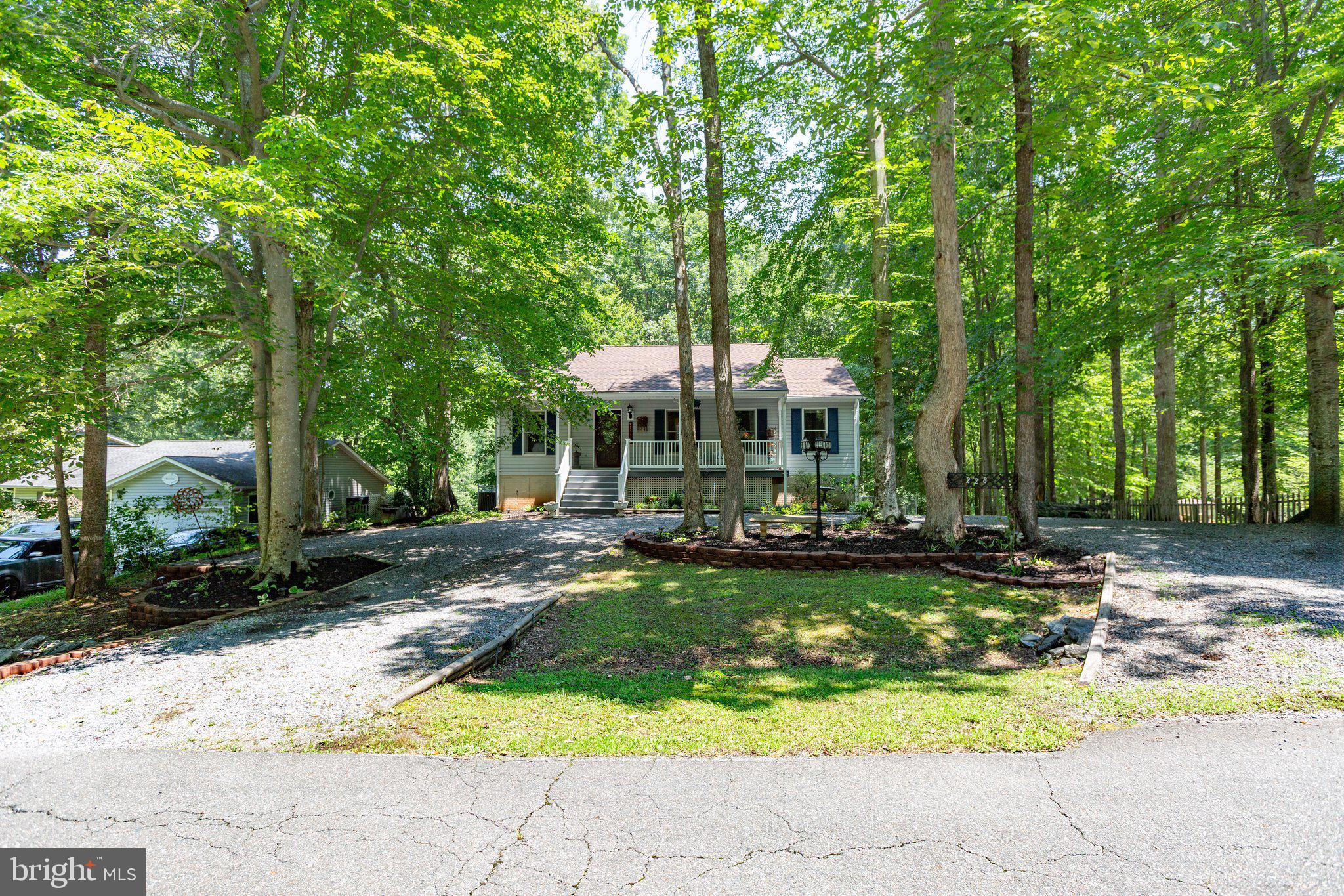 228 Cedar Ridge Drive Ruther Glen, VA 22546 - Photo 62 of 77 a view of a house with swimming pool and sitting area
