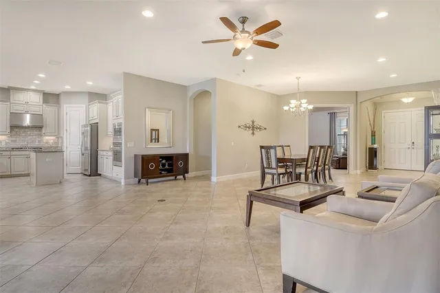 a kitchen with kitchen island granite countertop white cabinets and stainless steel appliances